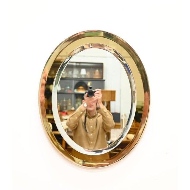 Magnificent oval double beveled mirror with a wonderful gold crystal mirror frame and a central beveled mirror. In...