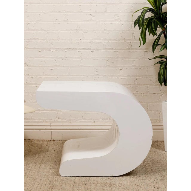 This vintage Pierre Cardin side table uses a white lacquer waterfall form to create a clean, continuous silhouette with a...