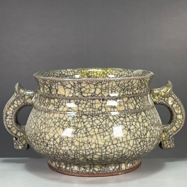 A striking Chinese porcelain censer (incense burner) featuring a classic Ge-type crackle glaze. The vessel has a...