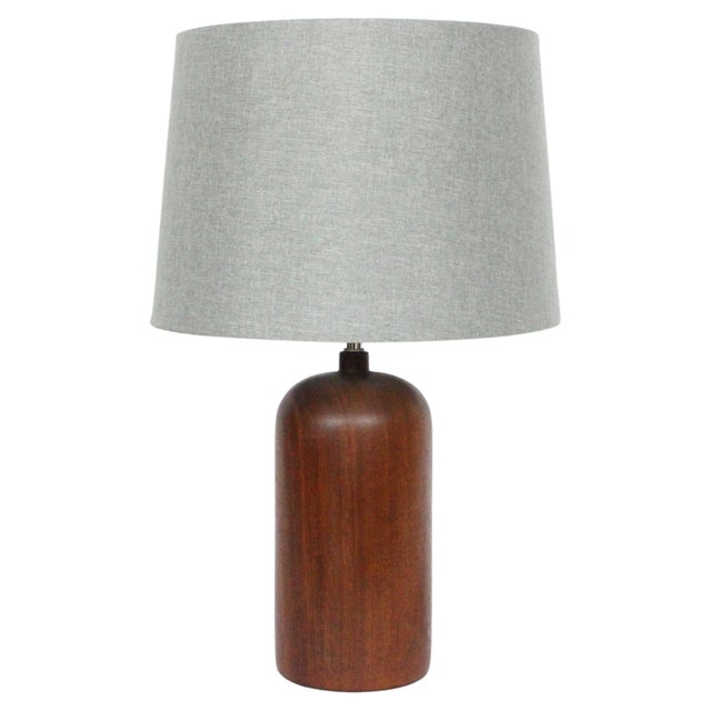 Danish Mid Century Modern turned solid Teak Table Lamp, Circa 1960. Featuring a rounded smooth beautifully grained Dark...