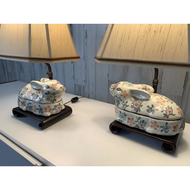 Beautiful Chinese export ceramic rabbits mounted on a scrolled wooden base with adjustable shade height. The rabbit is the...
