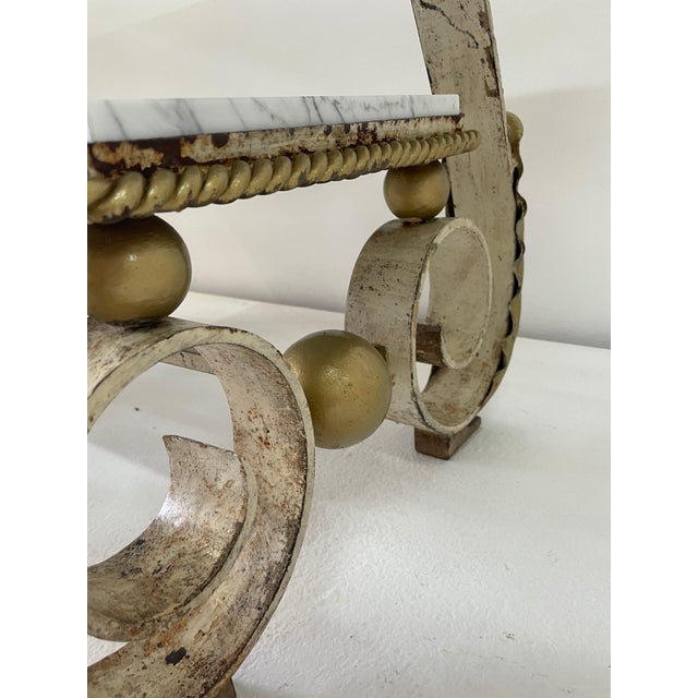 Scrolled iron legs with acanthus lead motif details. White marble newly replaced to both levels. Metal shows age and...