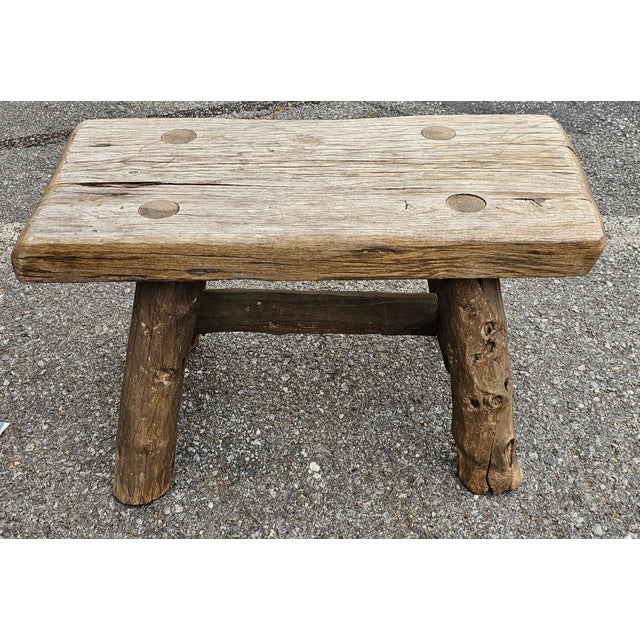 An Early American Style Rustic Stretcher Pine Log Bench. Measures 28.5" in width, 17" in depth and 17.5" in height.