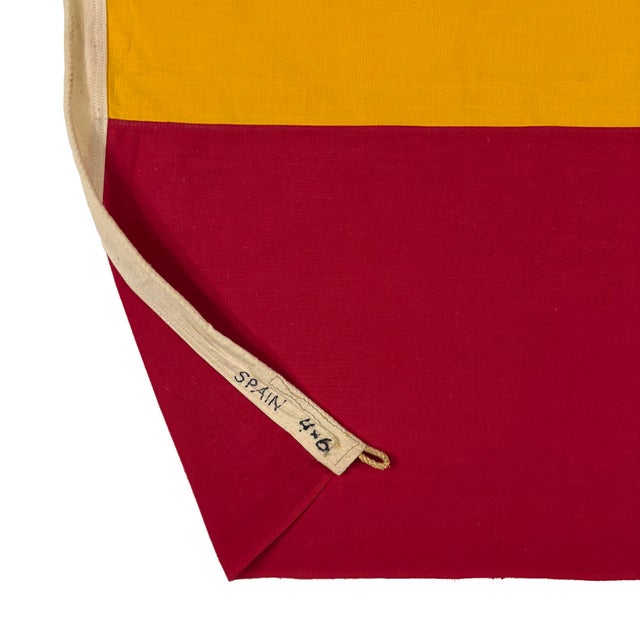 This vintage Spanish flag is made from cotton or a similar cloth with fully sewn panels. Please note staining and other...