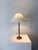 A minimalist 20th century Swedish table lamp. Formed in brass which has acquired a great patina, with a sleek unadorned...