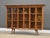 A mid century modern walnut bookcase with three glass doors. Made in the USA. Circa 1960’s. Original finish in excellent...