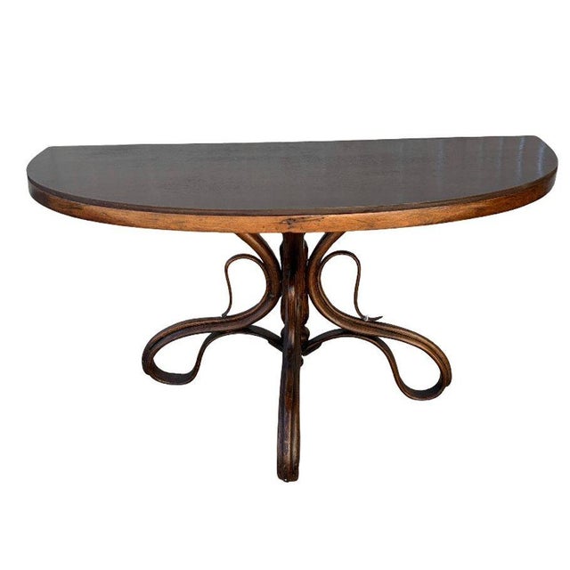Rare late Victorian polished oak scrolling occasional table by Thonet features a distinctive three scrolling legs richly...