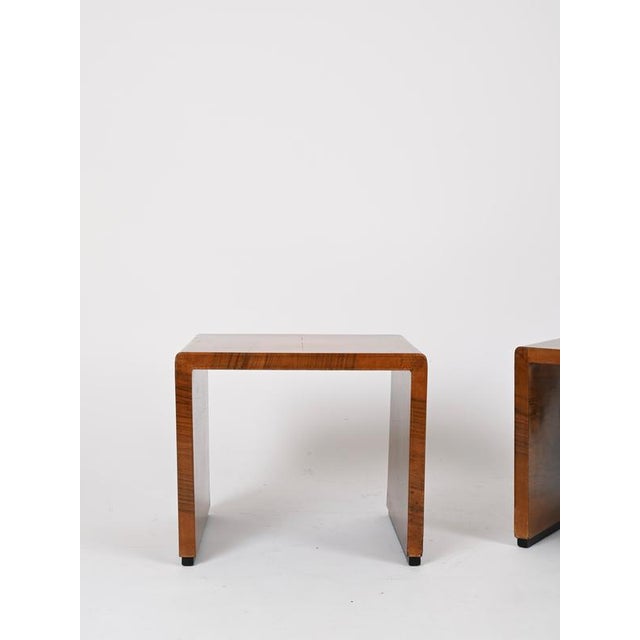 Elegant pair of Art Deco side tables or nightstands entirely made in walnut. These incredibly elegant and unique tables...