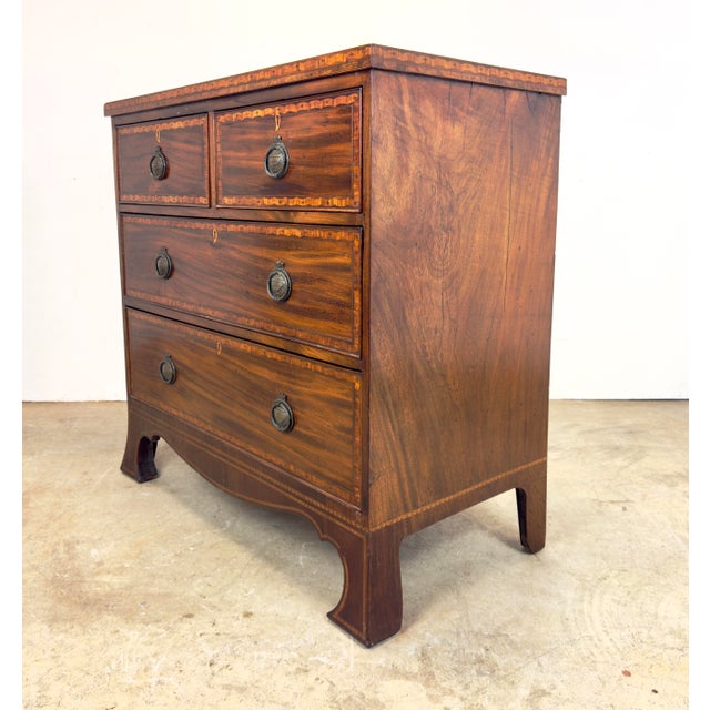 A gorgeous small chest in English George III or Regency style with detailed and elegant marquetry featuring cross in...