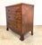 A gorgeous small chest in English George III or Regency style with detailed and elegant marquetry featuring cross in...