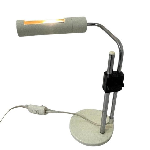 Desk lamp by Hala Zeist. White base and shade that are connected by two chromed metal rods. These can be adjusted in...