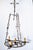 A circular, flat-base wrought iron chandelier, early 20th century, French. Base is suspended by 3 iron chains with...