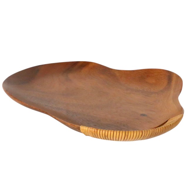 Sculptural Organic Mid Century Modern serving tray constructed of hand carved wood with a cane wrapped handle. This...