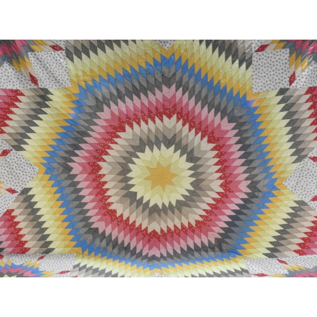 Vibrant colors make up this beautiful handmade vintage quilt. This quilt features a large star design in the center of the...