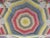 Vibrant colors make up this beautiful handmade vintage quilt. This quilt features a large star design in the center of the...