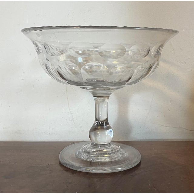 Antique 19th century American cut glass footed compote. Thumb and dot cut pattern with faceted rim. Bowl rises on a...