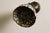 This Tiffany-style wall sconce is composed of stained glass in shimmering colors, soldered with tin. It is mounted on a...