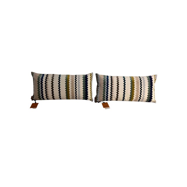 Pair of Missoni Home lumbar pillows in a sophisticated neutral chevron stripe palette featuring ivory, taupe, olive, aqua,...