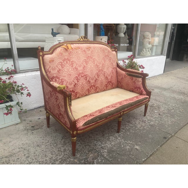 Louis XVI Style Loveseat in original satined red finish and gilt details. Fabulous shape and scale. Sourced from a...