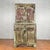An Indian rustic painted wood cabinet from the early 21st century with carved scrolling foliage and distressed patina....