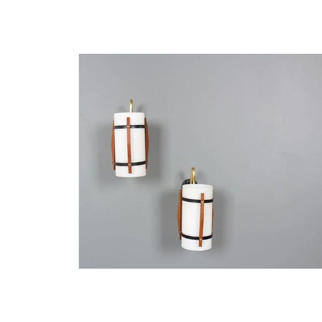 Set of 2 wall lights made in the 50s Wall bracket in black lacquered metal, teak and brass elements. Opaline glass...