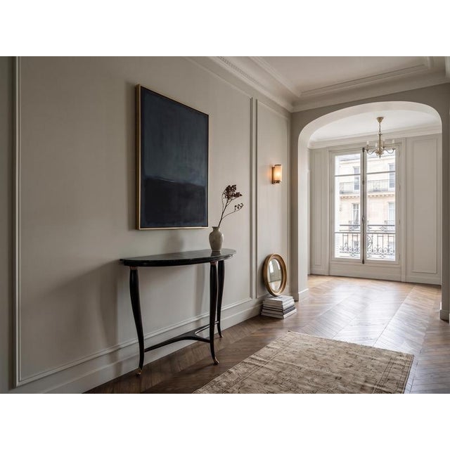 This elegant demilune console is a refined example of mid-century design, gracefully blending luxurious materials and...