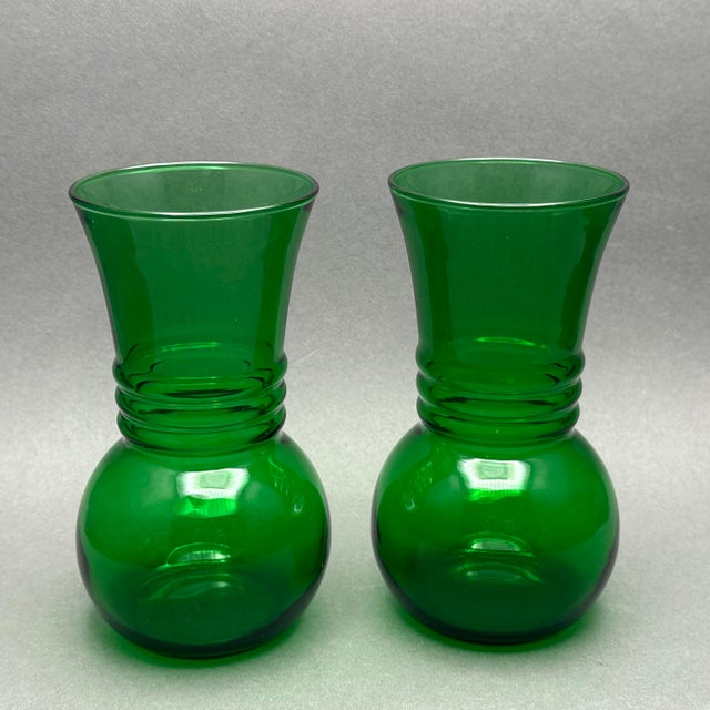 Vintage pair of MCM Anchor Hocking forest green ribbed glass vases. They are a bold forest green color with a bulbous...