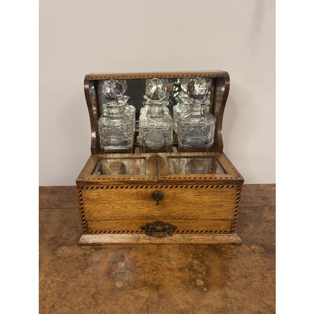Exceptional quality antique Victorian oak marquetry strung tantalus, having a quality oak tantalus with marquetry strung...