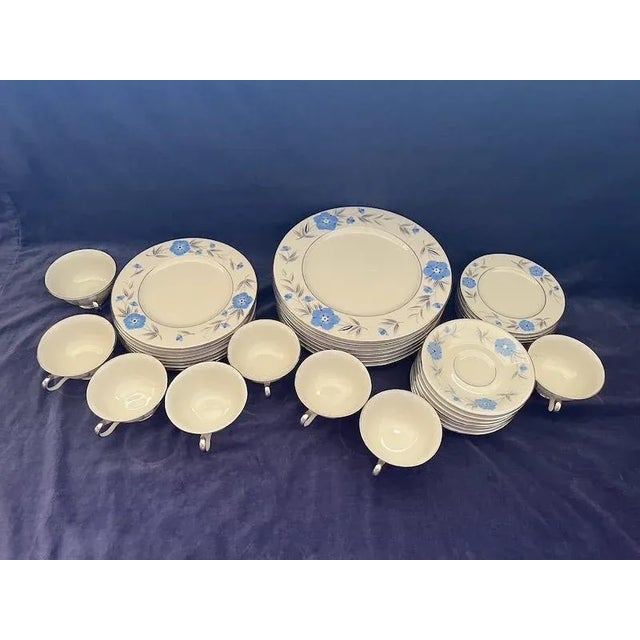 Mom's wedding china circa 1950. Little blue flowers with grey leaves and a platinum trim. Eight 5-piece sets: dinner...