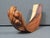 Sculptural hand-carved Suar wood wine bottle holder by Balinese artisan Nengah Sudarsana. The beautifully curved form is...
