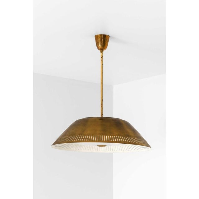 The ceiling lamp model 61-103, designed by Lisa Johansson-Pape and produced by Stockmann-Orno in Finland during the 1950s,...