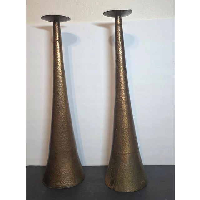 This product is a pair of vintage arts and crafts hammered copper candlestick candle holders, standing tall at 20 inches....