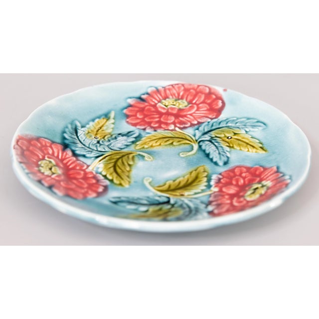 A lovely antique French majolica floral plate, circa 1890. This beautiful French country style plate has hand painted pink...