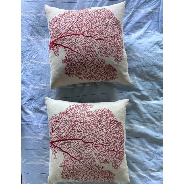Coral (red) embroidered pillows on natural linen cotton with feather down pillow inserts. Lightly worn. no visible marks....