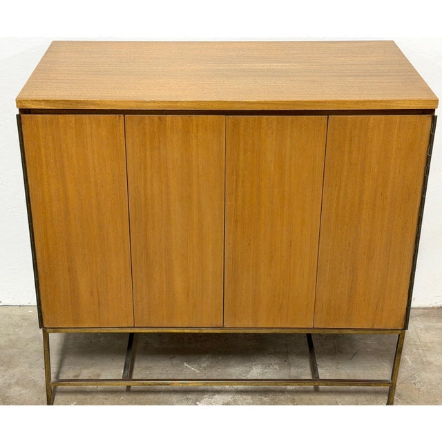 Paul McCobb for Calvin Furniture “Irwin Collection” Diminutive Bi-Fold Cabinet or Bar USA, circa 1950s A refined and...