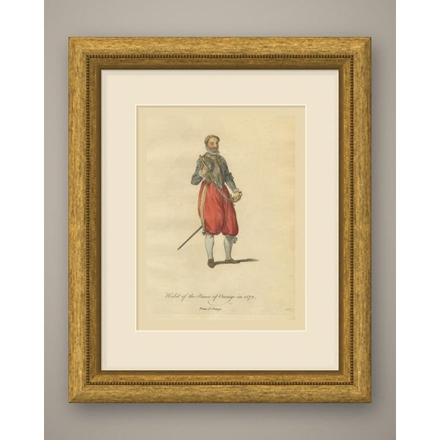 An original antique print, a copper engraving colored by hand, lettered "habit of the prince of orange in 1572." a bearded...