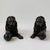 This pair of bronze lion sculptures depicts recumbent guardian lions resting with one paw placed upon a spherical orb. The...
