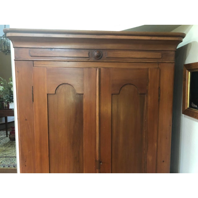 Large armoire in very nice condition. Tiny hole in back wall for electrical outlet access.