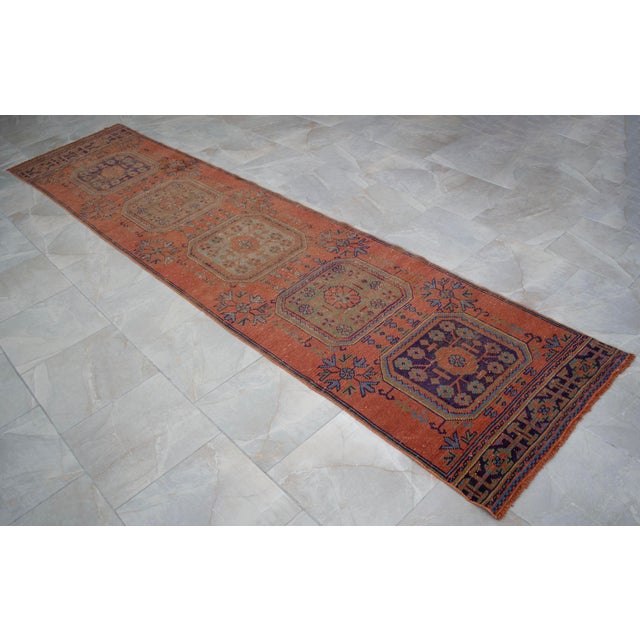 Vintage 1970s distressed Turkish Oushak rug runner. with light taupe (moderate vermilion) field and shades of sky blue,...