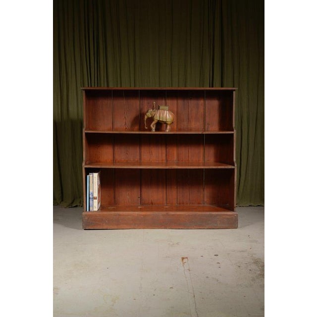 A charming English country house bookcase in pitch pine, with three shelves of different heights and lovely thick...