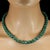 This striking 19‑inch necklace showcases natural emerald‑in‑matrix beads measuring approximately 9–10 mm, each one...