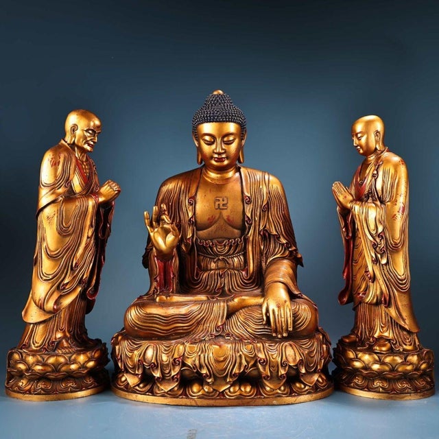 This exceptional set comprises three gilt bronze figures: a central seated Buddha flanked by two standing disciples. The...
