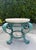Vintage hand-painted iron petite cocktail table with a turquoise and teal finish and gold-painted accent details...