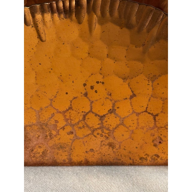 A hammered copper detail adorns the exterior of the solid copper napkin holder. The arched sides are gently crimped at the...