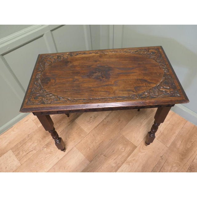 Elm Side Table with Celtic Carvings This is a good solid table, the top is thick and it has carved characters around the...