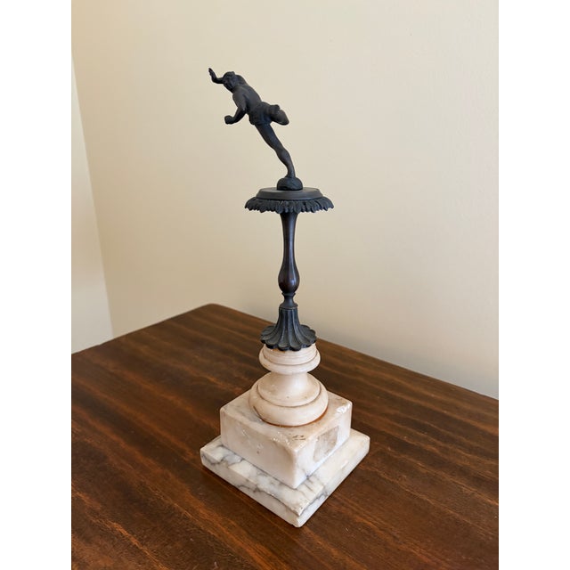 A beautifully composed Grand Tour–style figural sculpture depicting a dynamic classical dancer, mounted on a tiered marble...