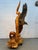 Make a striking statement with this large, hand-carved wooden sculpture depicting a soaring eagle intertwined with a tall...