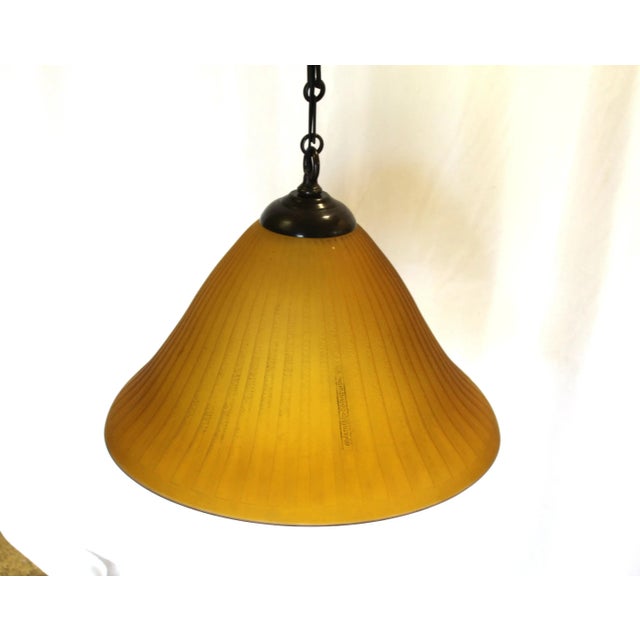 A Custom made Art Glass shade in Amber colored glass. Mid-Century/Deco looking pendant. The metal hardware is all brass...