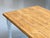 A generously sized dining table in a classic country style with a charming, handcrafted appeal. The white-painted frame...