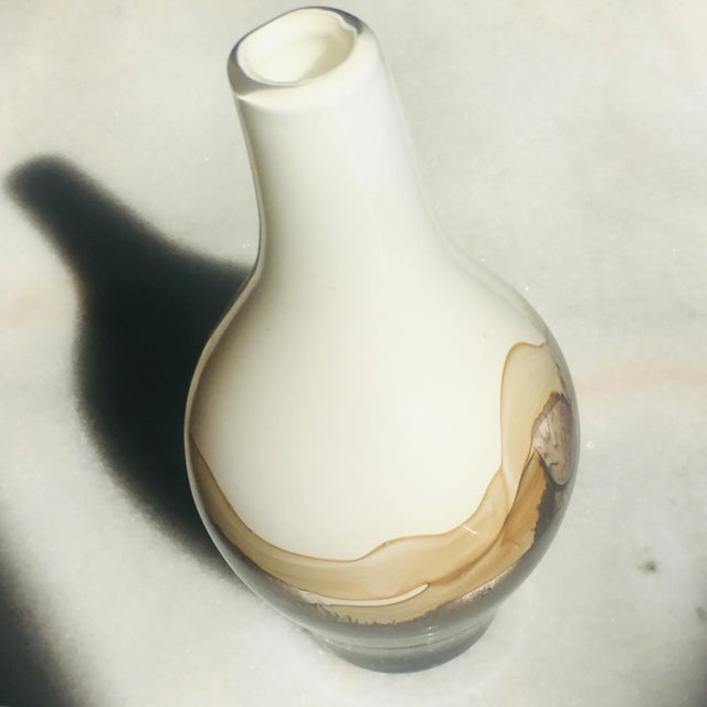 The alternating interplay between transparent and opaque Murano glass colors give this beautiful vase a different view...